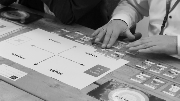 Players comparing their PaperBird task cards at the test table